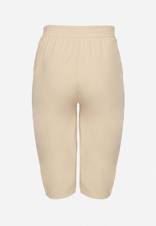 Born2be - Beżowe Luźne Spodnie z Bawełny z Wysokim Stanem 3/4 Lumelle. Okazja: na co dzień. Stan: podwyższony. Kolor: beżowy. Materiał: bawełna. Styl: klasyczny, casual