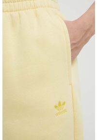 adidas Originals spodnie dresowe kolor żółty gładkie. Kolor: żółty. Materiał: dresówka. Wzór: gładki #3