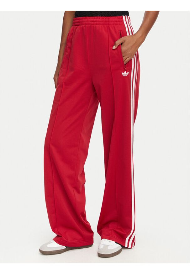Adidas - adidas Spodnie dresowe Firebird Loose Tracksuit KS4670 Czerwony Loose Fit. Kolor: czerwony. Materiał: syntetyk