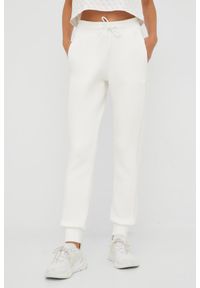 Guess - GUESS Beżowe spodnie dresowe damskie Allie Scuba, Rozmiar L. Kolor: beżowy. Materiał: dresówka #1