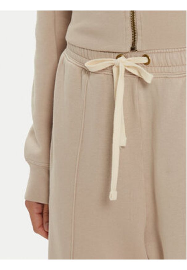 Champion Spodnie dresowe 117638 Beżowy Wide Leg. Kolor: beżowy. Materiał: bawełna
