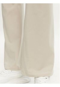 Adidas - adidas Legginsy Essentials Small Logo JD3072 Beżowy Flare Fit. Kolor: beżowy. Materiał: bawełna