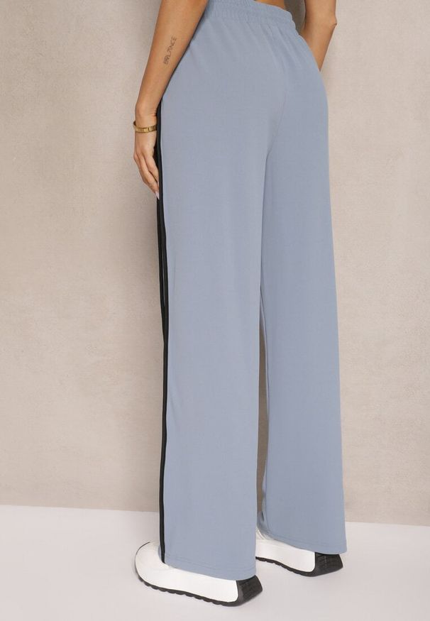 Renee - Niebieskie Szerokie Spodnie Dresowe High Waist Zdobione Lampasami Sopaline. Okazja: na spacer. Stan: podwyższony. Kolor: niebieski. Materiał: dresówka. Wzór: aplikacja. Styl: sportowy, elegancki
