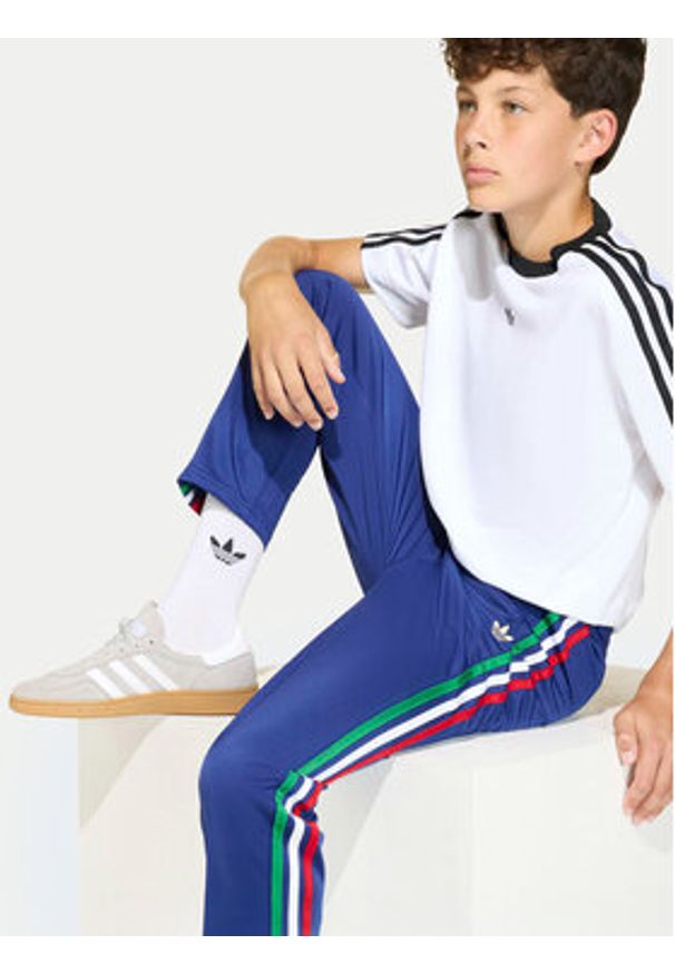 Adidas - adidas Spodnie dresowe Firebird KC9503 Niebieski Regular Fit. Kolor: niebieski. Materiał: syntetyk