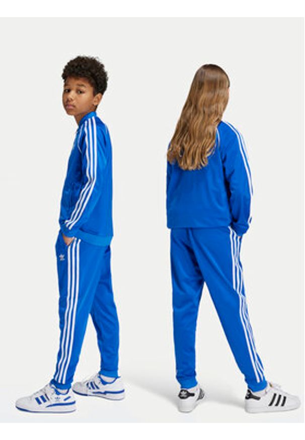 Adidas - adidas Spodnie dresowe adicolor SST IY4007 Niebieski Regular Fit. Kolor: niebieski. Materiał: syntetyk