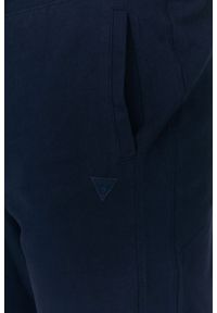 Guess - GUESS Granatowe męskie spodnie dresowe. Kolor: niebieski. Materiał: bawełna. Wzór: aplikacja #2