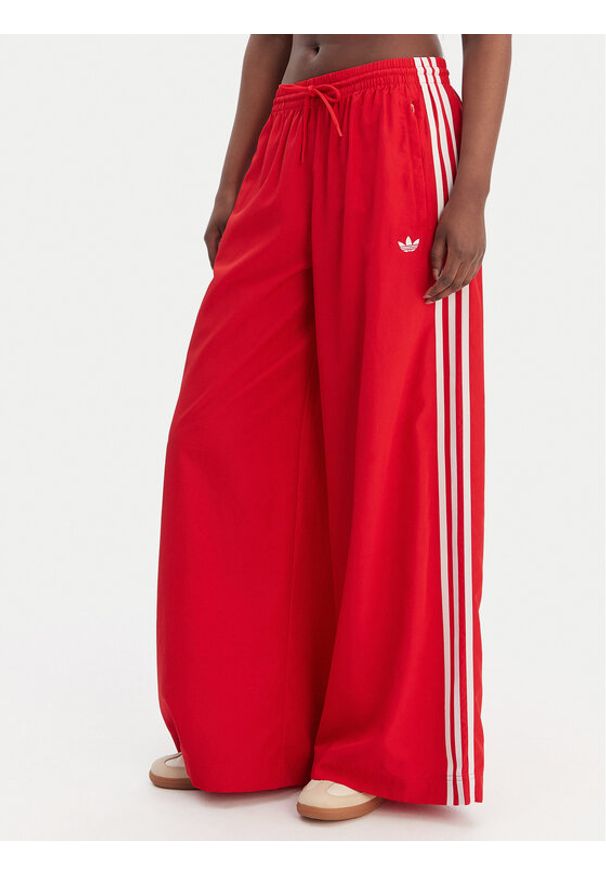 Adidas - adidas Spodnie dresowe Firebird Adilenium KD6299 Czerwony Regular Fit. Kolor: czerwony. Materiał: syntetyk