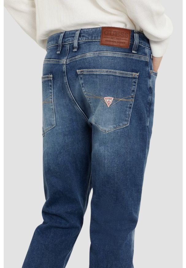 Guess - GUESS Granatowe męskie spodnie jeansowe Angels. Kolor: niebieski