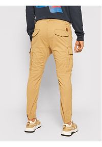 Alpha Industries Joggery Airman 188201 Beżowy Tapered Fit. Kolor: beżowy. Materiał: bawełna