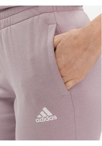 Adidas - adidas Spodnie dresowe Essentials Linear IS2105 Fioletowy Slim Fit. Kolor: fioletowy. Materiał: bawełna