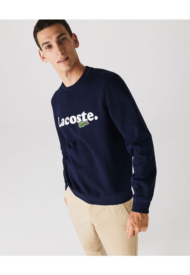 Lacoste - LACOSTE - Bawełniana bluza z logo. Okazja: na co dzień. Typ kołnierza: bez kaptura. Kolor: niebieski. Materiał: bawełna. Długość rękawa: długi rękaw. Długość: długie. Wzór: haft. Styl: klasyczny, casual