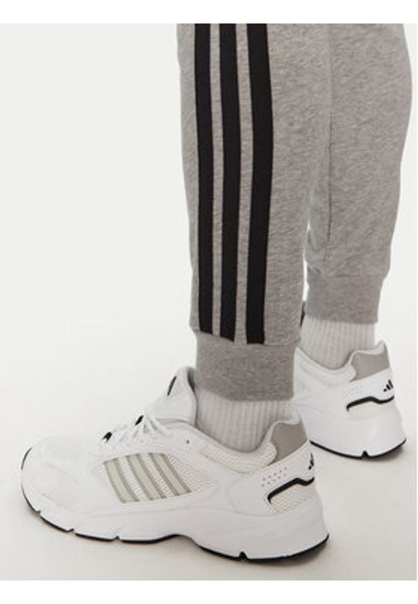 Adidas - adidas Spodnie dresowe Essential 3-Stripes JE6346 Szary Regular Fit. Kolor: szary. Materiał: bawełna, syntetyk
