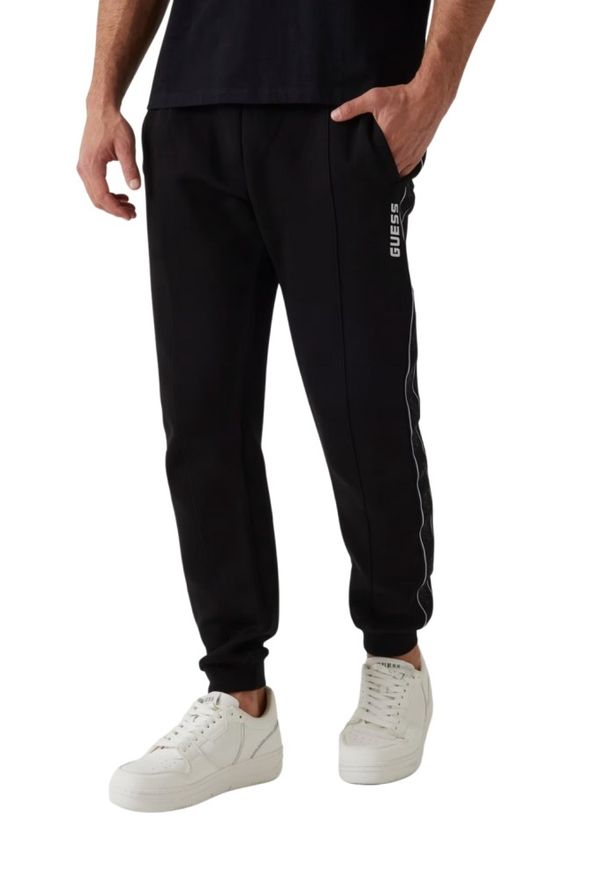Guess - GUESS Czarne męskie spodnie dresowe z lampasami Mickey, Rozmiar L. Kolor: czarny. Materiał: dresówka
