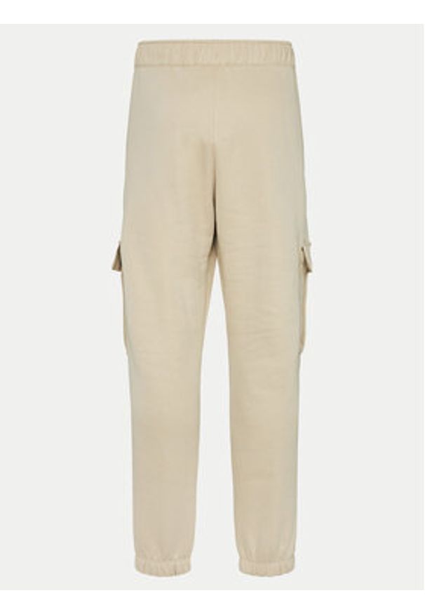 Champion Spodnie dresowe 117554 Beżowy Loose Fit. Kolor: beżowy. Materiał: bawełna