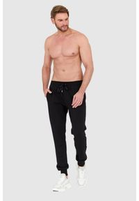 Dolce and Gabbana - DOLCE & GABBANA Czarne spodnie dresowe z haftowanym logo. Kolor: czarny. Materiał: bawełna. Wzór: haft #2