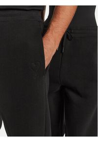 AMI PARIS Spodnie dresowe UTR237.749 Czarny Relaxed Fit. Kolor: czarny. Materiał: syntetyk #3