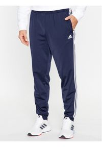 Adidas - adidas Spodnie dresowe Essentials Warm-Up 3-Stripes H46106 Granatowy Regular Fit. Kolor: niebieski. Materiał: dresówka, syntetyk #1