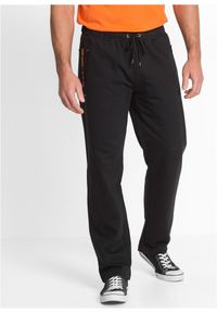 bonprix - Spodnie sportowe z praktycznymi kieszeniami zapinanymi na zamek. Kolor: czarny. Styl: sportowy #1