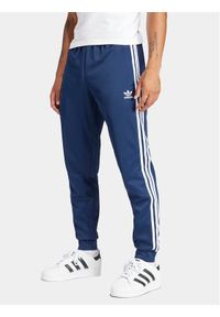 Adidas - adidas Spodnie dresowe adicolor Classics SST IR9887 Granatowy Slim Fit. Kolor: niebieski. Materiał: bawełna, syntetyk