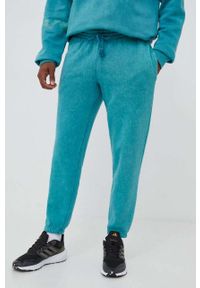 Adidas - adidas spodnie dresowe kolor turkusowy wzorzyste. Kolor: turkusowy. Materiał: dresówka #1