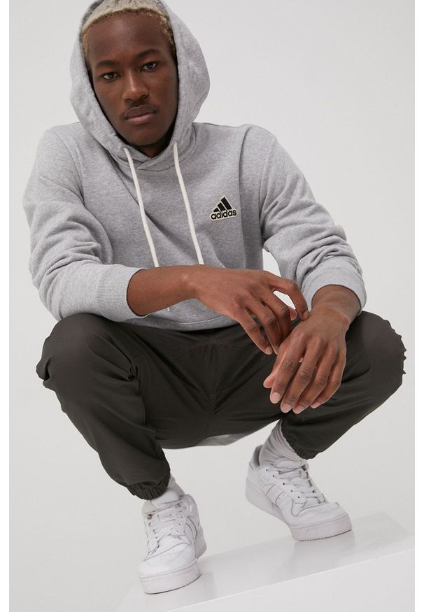 Adidas - adidas bluza męska kolor szary z kapturem z aplikacją. Typ kołnierza: kaptur. Kolor: szary. Materiał: dzianina, bawełna. Wzór: aplikacja