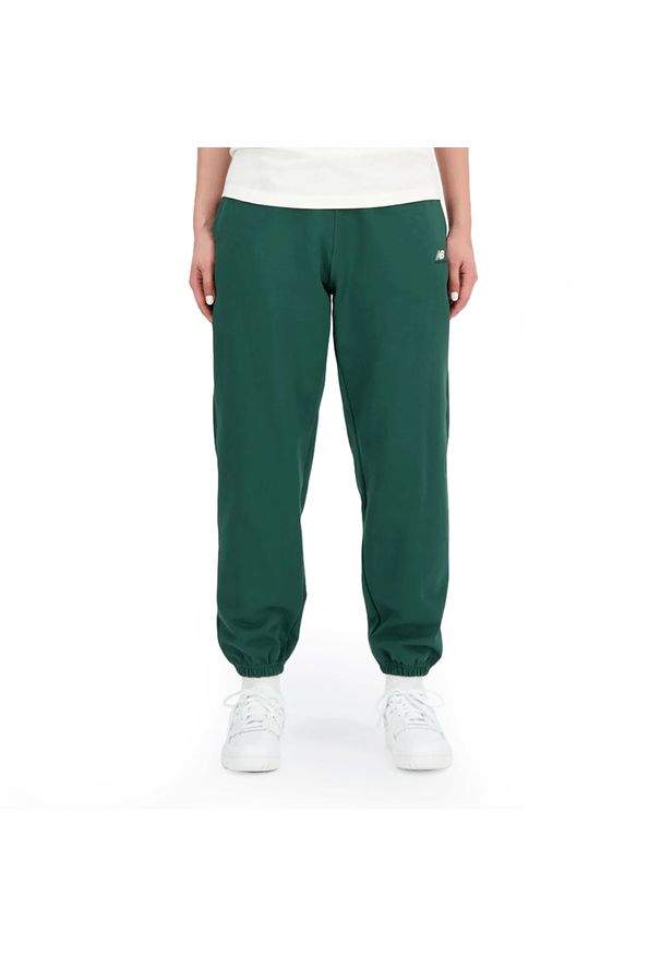 Spodnie New Balance WP31503NWG - zielone. Kolor: zielony. Materiał: bawełna, dresówka