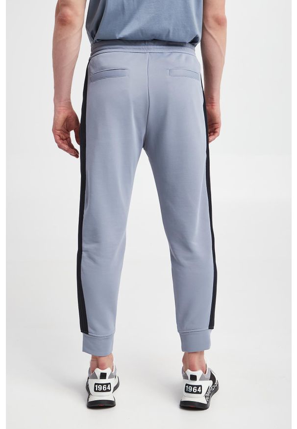 Emporio Armani - Spodnie dresowe męskie EMPORIO ARMANI. Materiał: dresówka
