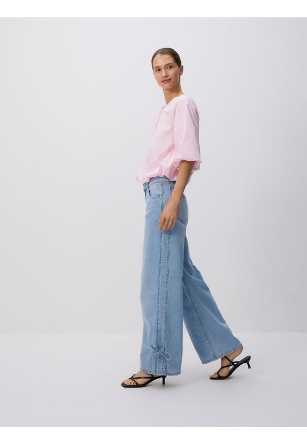 Reserved - Jeansy wide leg z kokardkami - niebieski. Kolor: niebieski