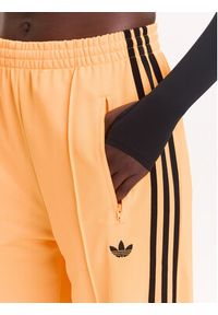 Adidas - adidas Spodnie dresowe adicolor Classic Firebird JY2694 Żółty Loose Fit. Kolor: żółty. Materiał: syntetyk #5