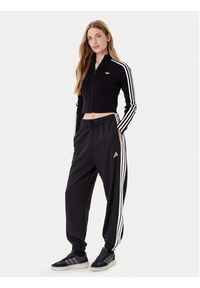 Adidas - adidas Spodnie dresowe Essentials 3-Stripes Fleece JE1276 Czarny Loose Fit. Kolor: czarny. Materiał: bawełna