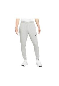 Spodnie sportowe męskie Nike Drifit Trapered. Kolor: szary. Materiał: dresówka