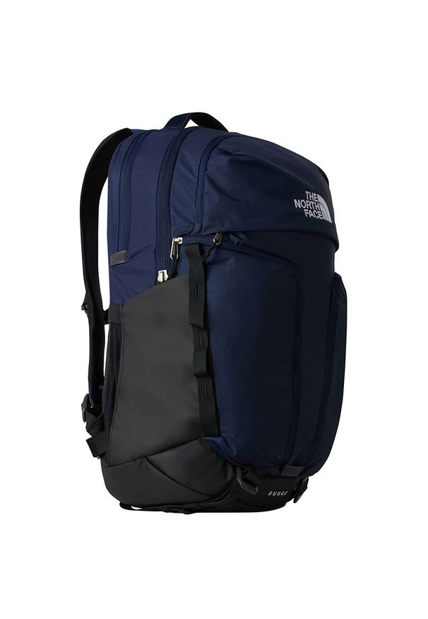 Plecak The North Face Surge 0A52SG53Z1 - granatowy. Kolor: niebieski. Materiał: polar. Wzór: paski. Styl: sportowy, casual
