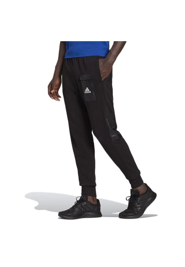 Adidas - Spodnie adidas Essentials Brandlove French Terry HE1776 - czarne. Kolor: czarny. Materiał: wiskoza, materiał, bawełna, dresówka, poliester