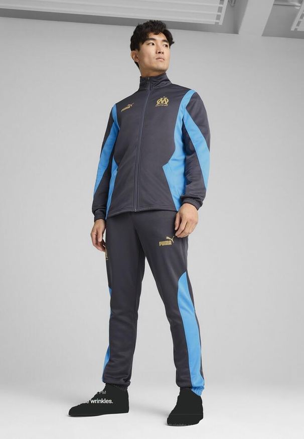 Puma - Męskie spodnie Olympique de Marseille ftblNRGY+ PUMA. Kolor: wielokolorowy, beżowy, szary