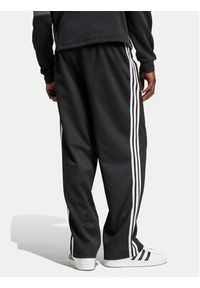Adidas - adidas Spodnie dresowe adicolor Firebird IZ4801 Czarny Baggy Fit. Kolor: czarny. Materiał: syntetyk, bawełna #2