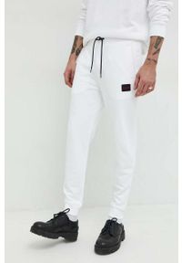 Hugo - HUGO spodnie dresowe bawełniane męskie kolor biały gładkie. Kolor: biały. Materiał: bawełna, dresówka. Wzór: gładki #1
