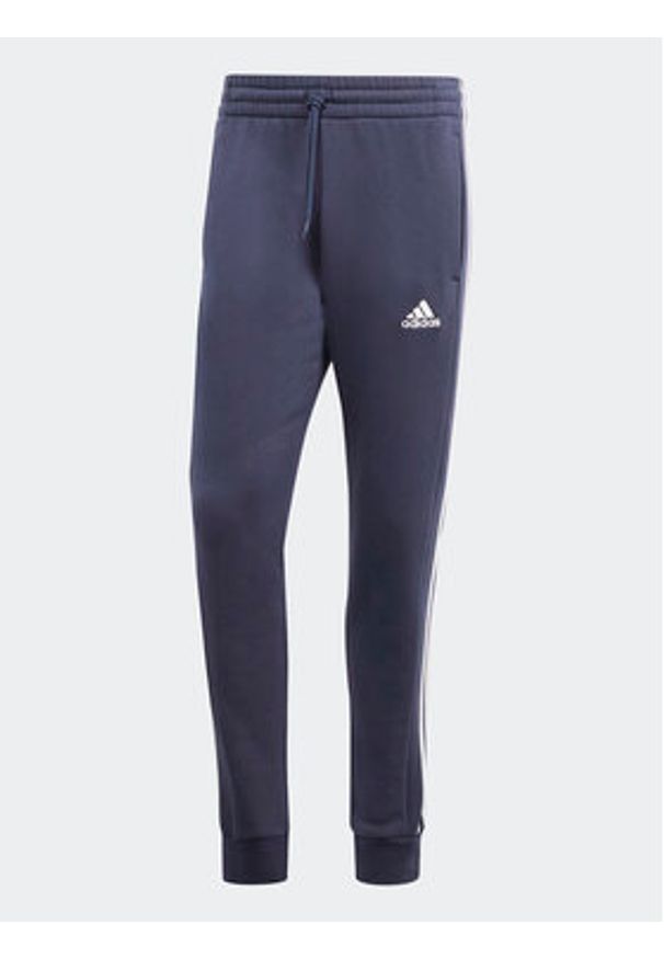 Adidas - adidas Spodnie dresowe Essentials Fleece 3-Stripes Cuff IJ6493 Granatowy Regular Fit. Kolor: niebieski. Materiał: bawełna