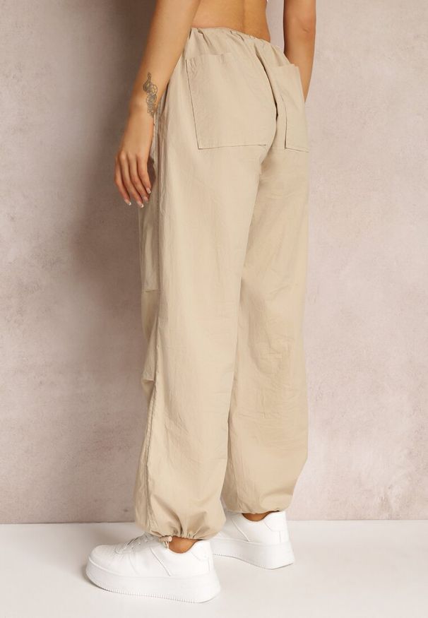 Renee - Beżowe Szerokie Spodnie Spadochronowe ze Stoperami Ranyah. Stan: podwyższony. Kolor: beżowy. Materiał: tkanina, bawełna. Wzór: gładki, jednolity