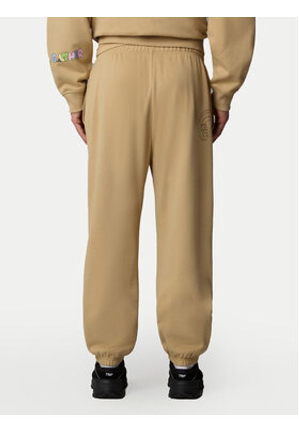 The North Face Spodnie dresowe Unisex Mountain Cleanup NF0A8C2W Beżowy Relaxed Fit. Kolor: beżowy. Materiał: bawełna