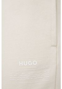 Hugo - HUGO spodnie bawełniane męskie kolor beżowy z nadrukiem. Kolor: beżowy. Materiał: bawełna. Wzór: nadruk