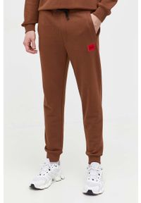 Hugo - HUGO spodnie dresowe bawełniane kolor brązowy melanżowe. Kolor: brązowy. Materiał: bawełna, dresówka, dzianina. Wzór: gładki, melanż #1