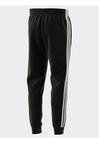 Adidas - adidas Spodnie dresowe IB4030 Czarny Regular Fit. Kolor: czarny. Materiał: bawełna