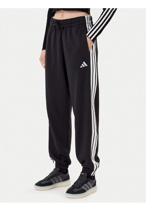 Adidas - adidas Spodnie dresowe Essentials 3-Stripes Fleece JE1276 Czarny Loose Fit. Kolor: czarny. Materiał: bawełna