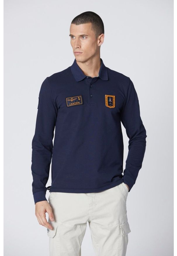 Aeronautica Militare - AERONAUTICA MILITARE Granatowe męskie polo z długim rękawem Piqué, Rozmiar M. Typ kołnierza: polo. Kolor: niebieski. Długość rękawa: długi rękaw. Długość: długie