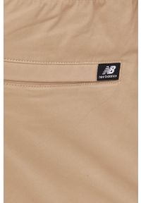 New Balance spodnie męskie kolor beżowy w fasonie cargo. Okazja: na co dzień. Kolor: beżowy. Materiał: tkanina, bawełna. Wzór: gładki. Styl: casual