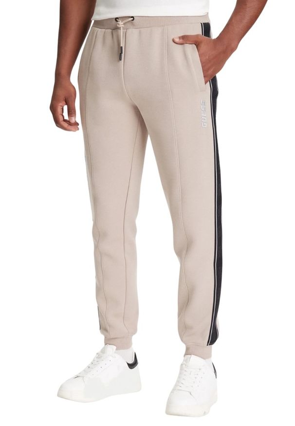 Guess - GUESS Beżowe spodnie męskie z lampasami Mickey, Rozmiar M. Kolor: beżowy