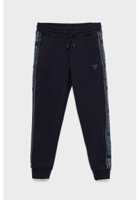 Guess spodnie dresowe dziecięce kolor granatowy z aplikacją. Okazja: na co dzień. Kolor: niebieski. Materiał: dresówka. Wzór: aplikacja. Styl: casual