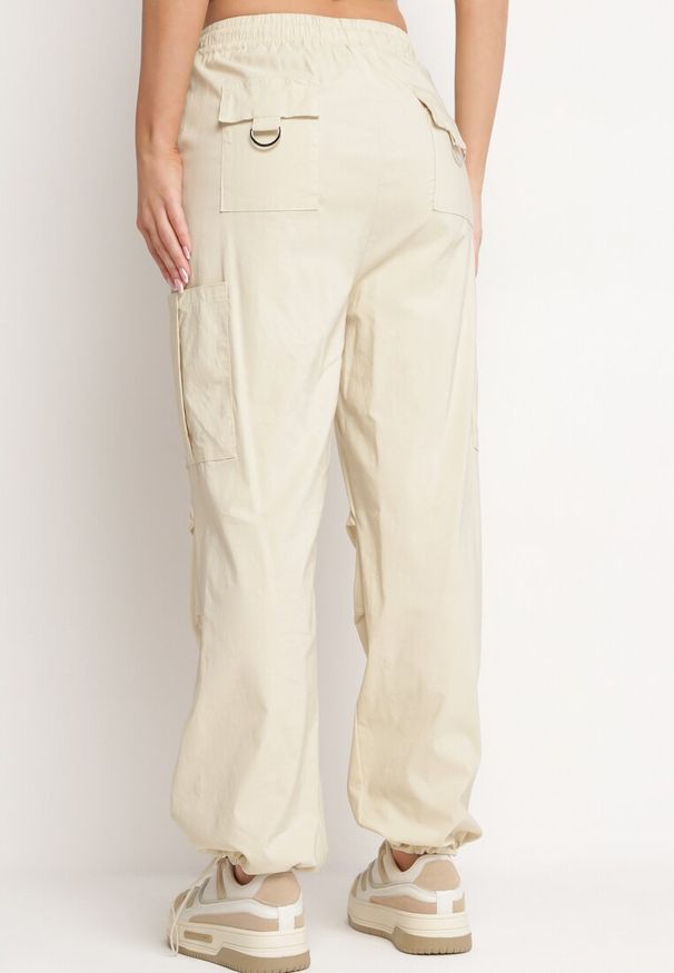 Born2be - Jasnobeżowe Spodnie Bojówki z Wysokim Stanem z Gumką w Pasie z Kieszeniami Biorella. Okazja: na co dzień. Stan: podwyższony. Kolor: beżowy. Długość: długie. Styl: casual, elegancki