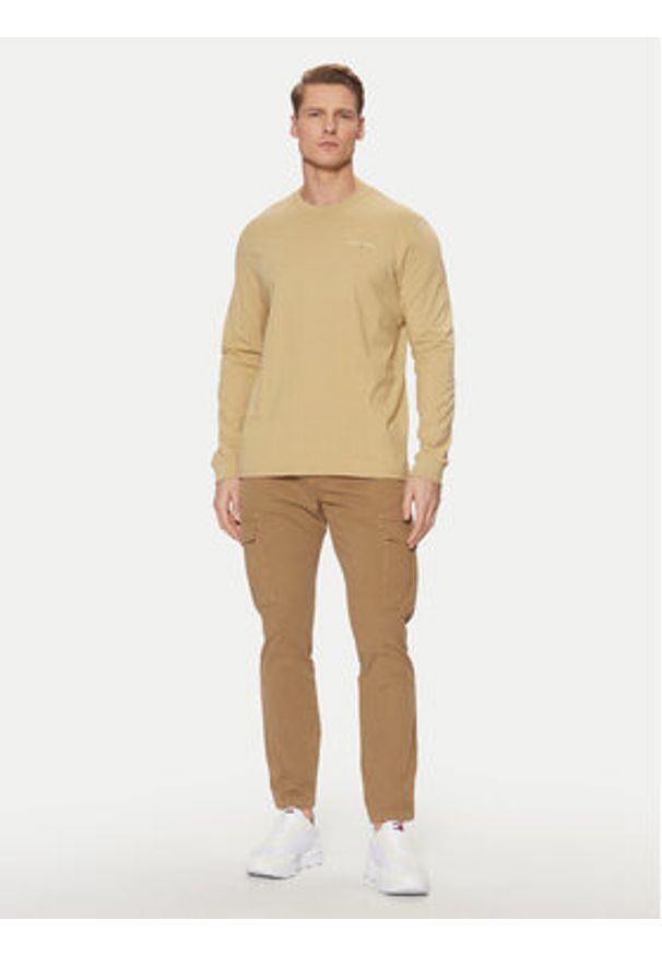 Tommy Jeans Spodnie materiałowe Austin DM0DM20281 Beżowy Regular Fit. Kolor: beżowy. Materiał: bawełna