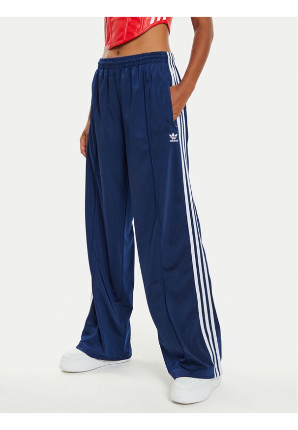 Adidas - adidas Spodnie dresowe Firebird IL3817 Granatowy Loose Fit. Kolor: niebieski. Materiał: syntetyk
